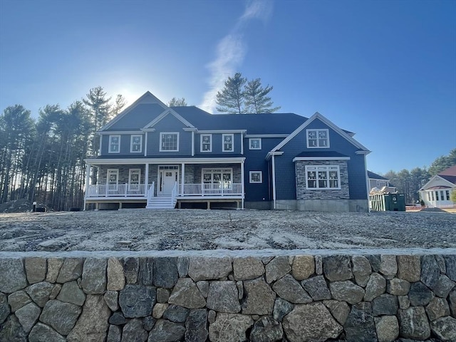 view of front facade featuring stone siding and a porch