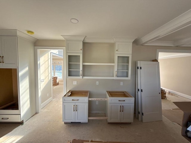 kitchen with crown molding, baseboards, and open shelves