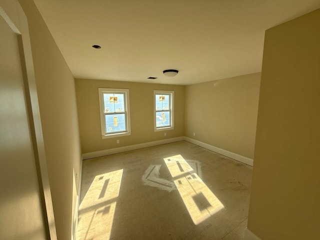 empty room with baseboards and visible vents