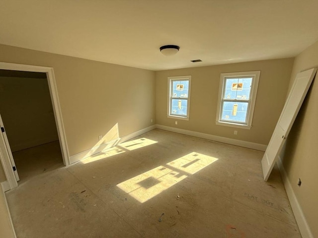 unfurnished bedroom with baseboards and visible vents