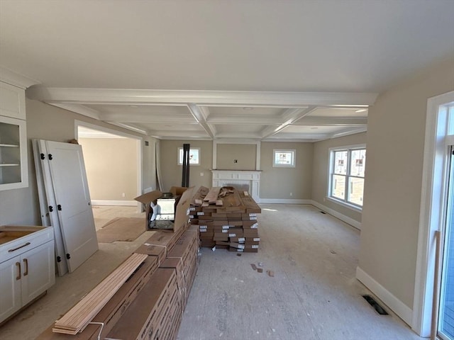 unfurnished living room featuring visible vents, baseboards, coffered ceiling, and a fireplace