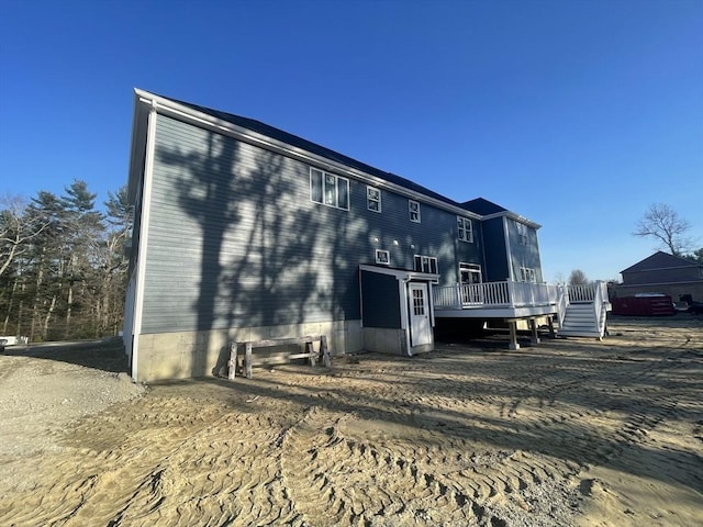 rear view of house featuring a deck