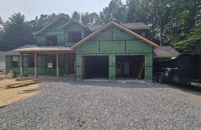 113 Newton St, West Boylston, MA 01583 - property in mid-construction with gravel driveway, covered porch, and a garage