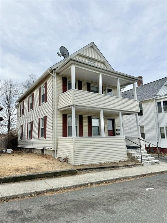 neoclassical / greek revival house featuring a balcony and covered porch