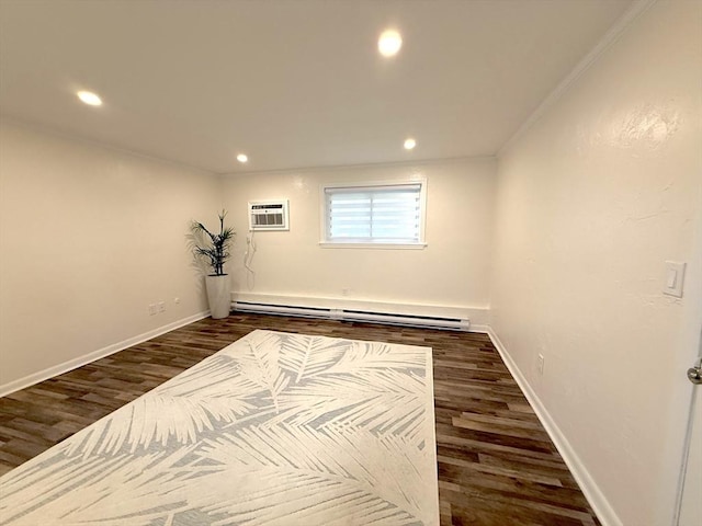 16 Erick Rd Unit 7, Mansfield, MA 02048 - below grade area featuring baseboard heating, dark wood finished floors, a wall unit AC, recessed lighting, and ornamental molding