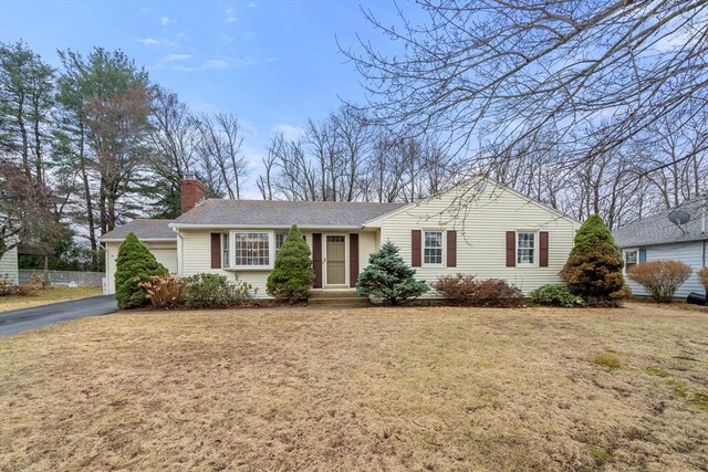 single story home featuring fence, a front lawn, a chimney, and a shingled roof