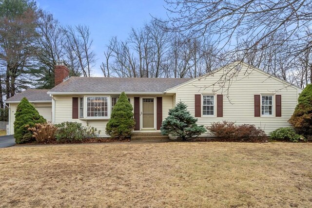 single story home with a front yard, a garage, roof with shingles, and a chimney