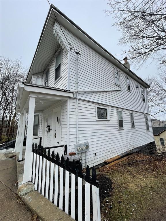 view of side of home with covered porch