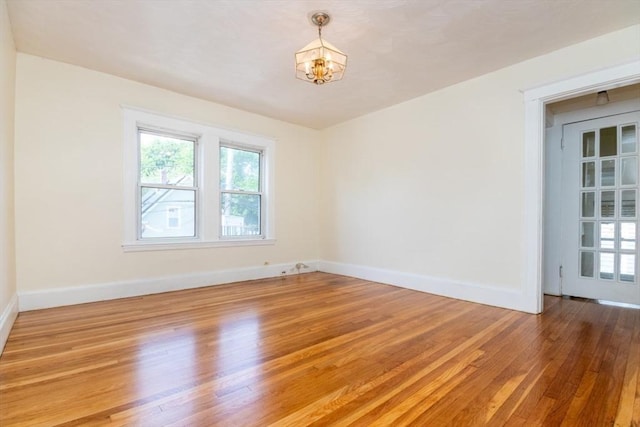 57 Ardale St, Boston, MA 02131 - empty room featuring a chandelier, light wood finished floors, and baseboards
