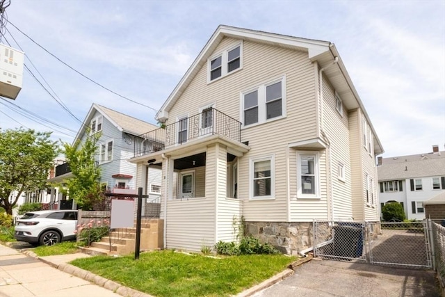 57 Ardale St, Boston, MA 02131 - american foursquare style home featuring a balcony and a gate