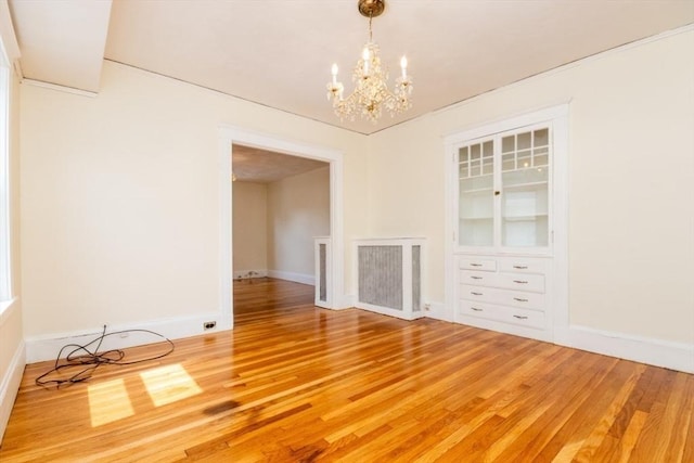 57 Ardale St, Boston, MA 02131 - unfurnished dining area featuring a chandelier, light wood-style flooring, and baseboards