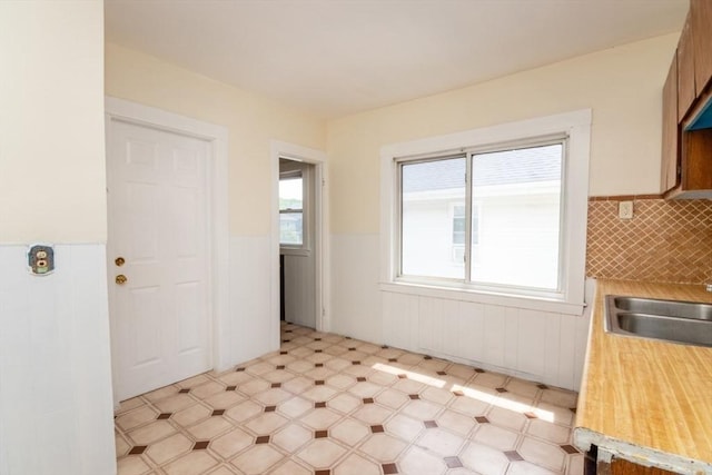 57 Ardale St, Boston, MA 02131 - kitchen with light flooring, a wainscoted wall, light countertops, and a sink