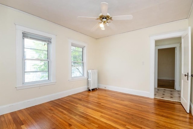 57 Ardale St, Boston, MA 02131 - empty room with radiator heating unit, light wood-style flooring, baseboards, and a ceiling fan