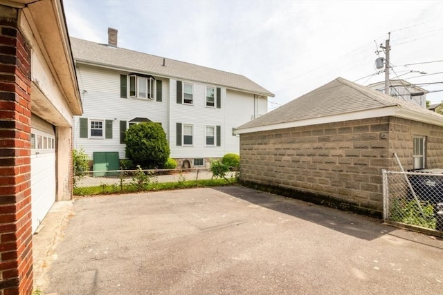 57 Ardale St, Boston, MA 02131 - back of property featuring a garage and a chimney