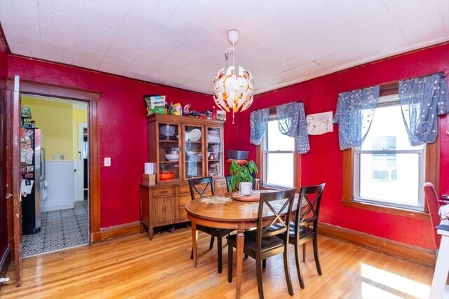 57 Ardale St, Boston, MA 02131 - dining area featuring a chandelier, wood finished floors, and baseboards
