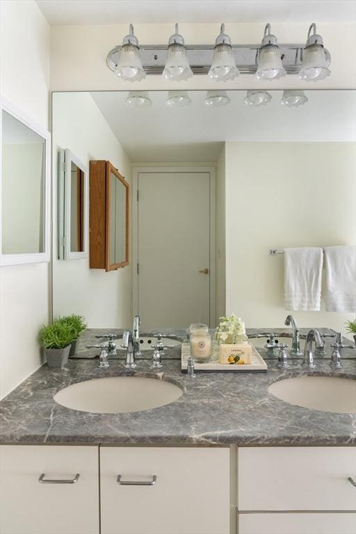 bathroom with double vanity and a sink