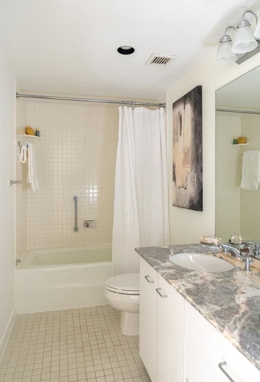 bathroom with vanity, shower / bathtub combination with curtain, visible vents, tile patterned flooring, and toilet