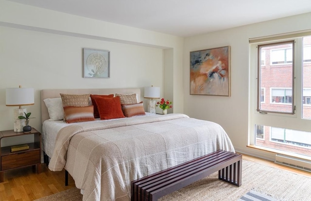 bedroom featuring visible vents and wood finished floors