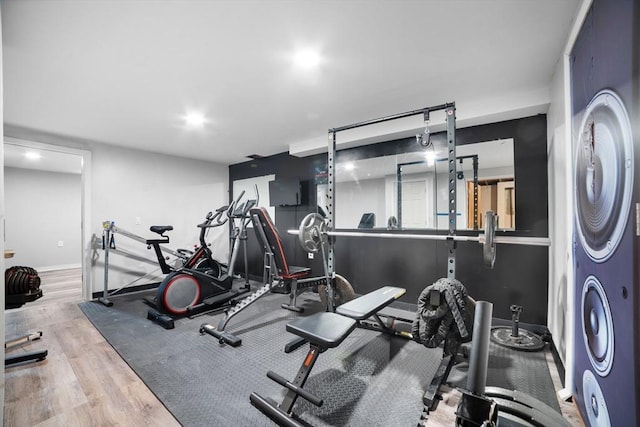 workout room with baseboards and wood finished floors