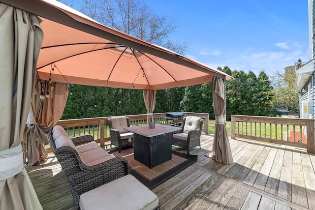 wooden deck featuring outdoor dining space and a gazebo