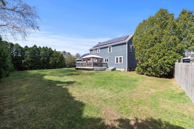 view of yard featuring fence and a wooden deck