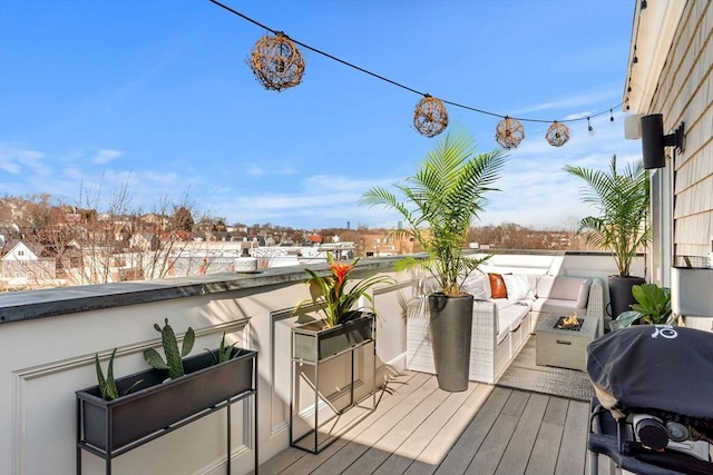 wooden deck featuring area for grilling