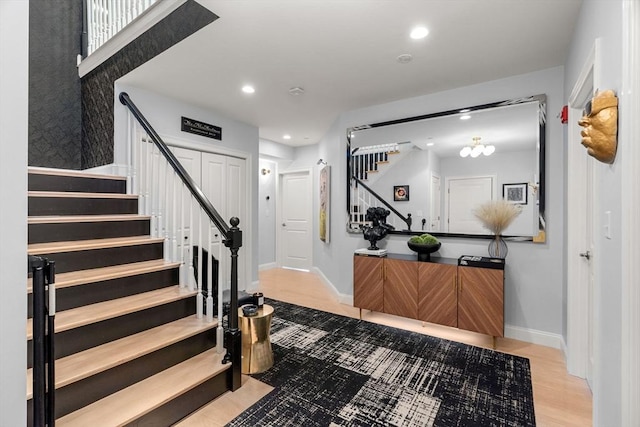 foyer featuring recessed lighting, baseboards, and stairs