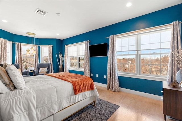 bedroom featuring recessed lighting, visible vents, baseboards, and wood finished floors