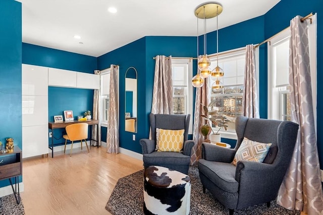 living area with recessed lighting, baseboards, and wood finished floors