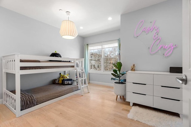 bedroom with recessed lighting, baseboards, and wood finished floors