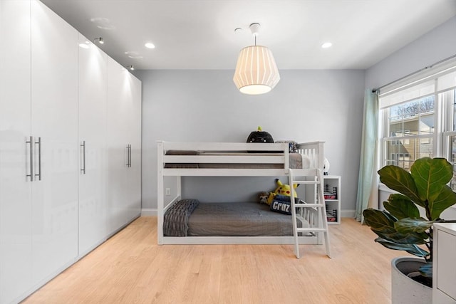 bedroom with recessed lighting, baseboards, and wood finished floors