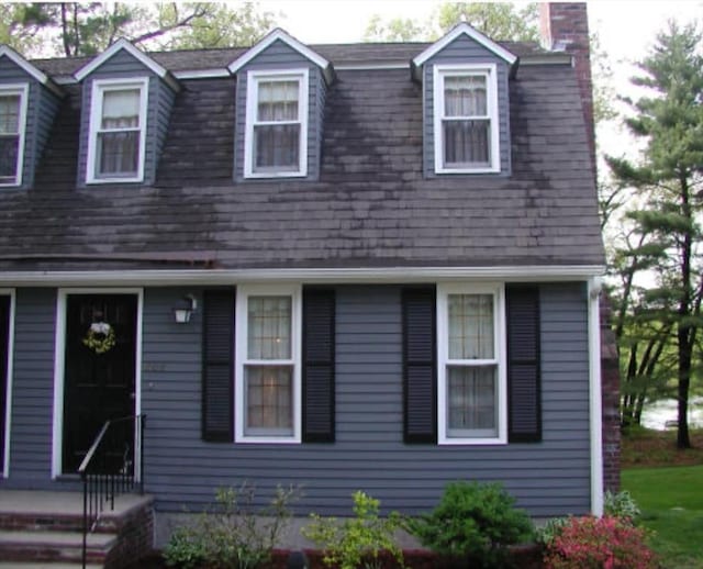 colonial inspired home with a chimney