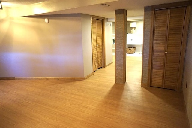 interior space featuring baseboards and light wood-style floors