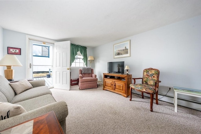 carpeted living room with a baseboard heating unit