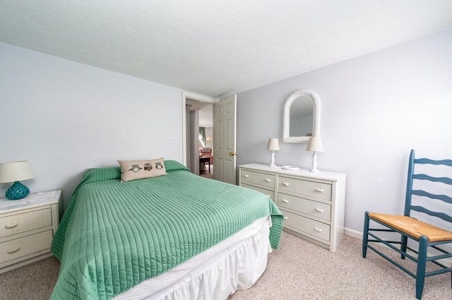 bedroom featuring light carpet and baseboards