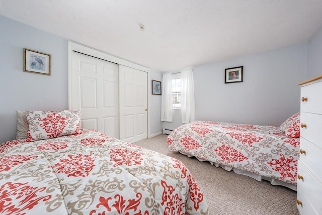 carpeted bedroom featuring a closet and baseboard heating