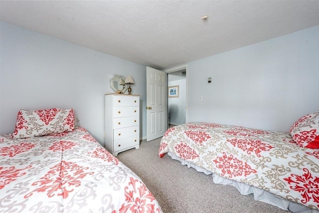 bedroom with light carpet and a textured ceiling