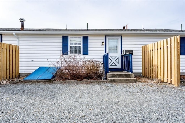 view of front of property featuring fence