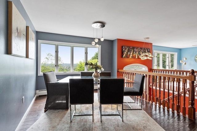 82 Powow St, Amesbury, MA 01913 - dining room featuring wood finished floors, a baseboard radiator, and a chandelier