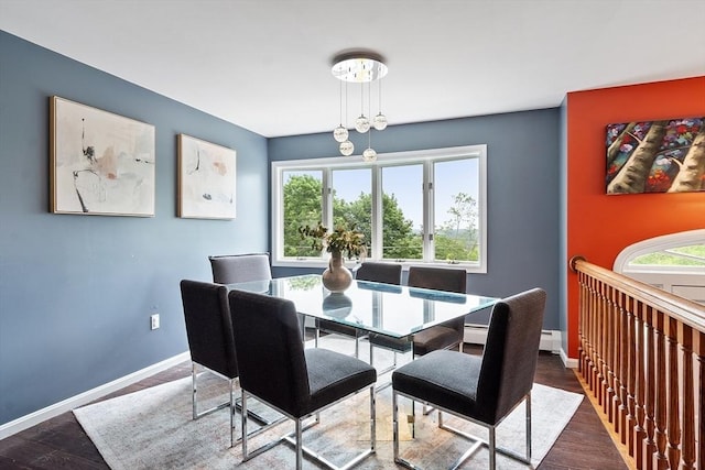 82 Powow St, Amesbury, MA 01913 - dining space featuring wood finished floors and a baseboard heating unit