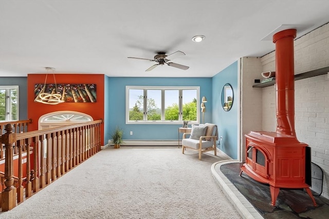 82 Powow St, Amesbury, MA 01913 - bedroom featuring carpet floors, a wood stove, baseboard heating, and a ceiling fan