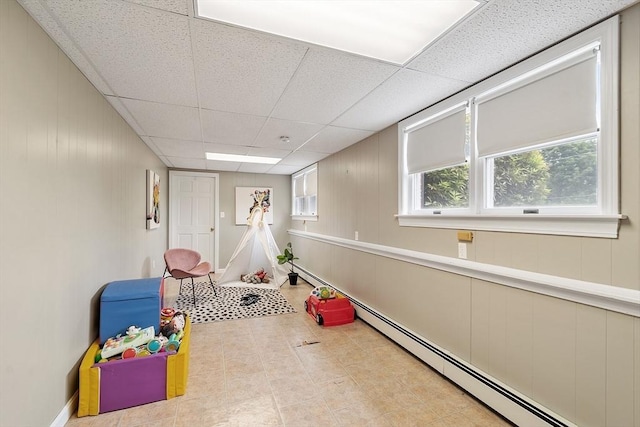 82 Powow St, Amesbury, MA 01913 - rec room with a baseboard radiator, a drop ceiling, and wood walls