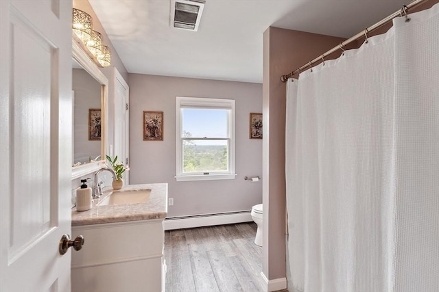 82 Powow St, Amesbury, MA 01913 - full bath featuring a baseboard heating unit, vanity, and wood finished floors