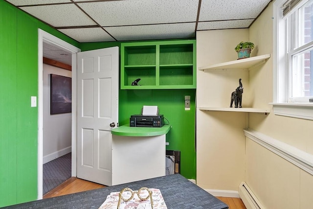 82 Powow St, Amesbury, MA 01913 - office area featuring a baseboard heating unit, wood finished floors, and a paneled ceiling