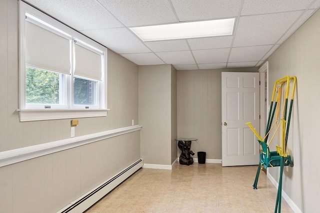 82 Powow St, Amesbury, MA 01913 - interior space featuring a baseboard heating unit, a drop ceiling, and wooden walls
