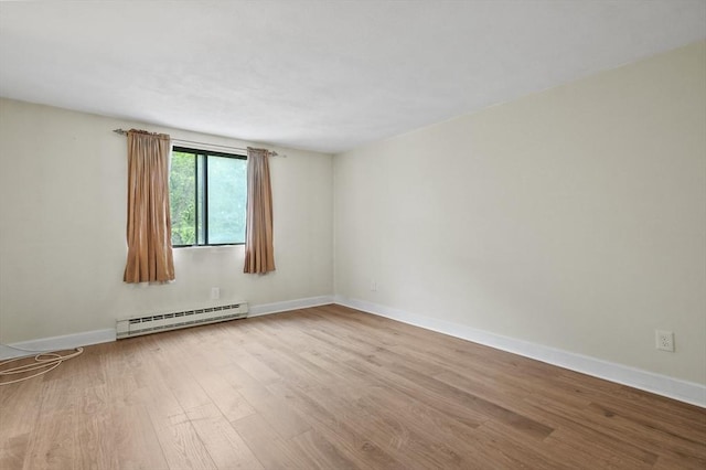 9 Broadway Unit 217, Saugus, MA 01906 - spare room with a baseboard heating unit, wood finished floors, and baseboards