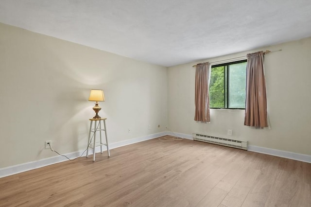 9 Broadway Unit 217, Saugus, MA 01906 - unfurnished room featuring a baseboard radiator, wood finished floors, and baseboards