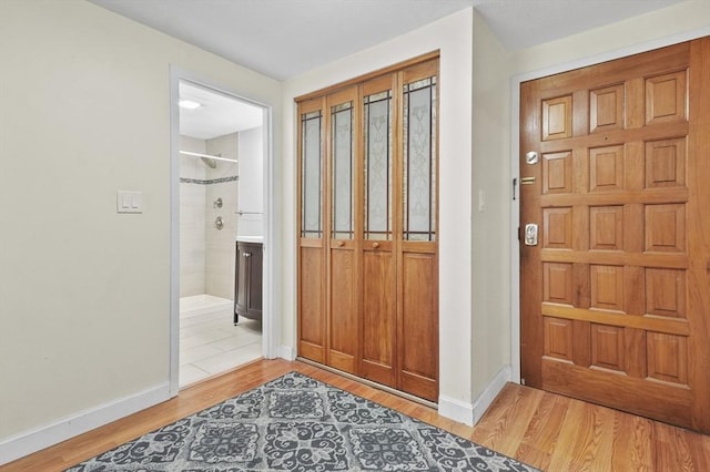 9 Broadway Unit 217, Saugus, MA 01906 - foyer entrance with light wood-type flooring and baseboards
