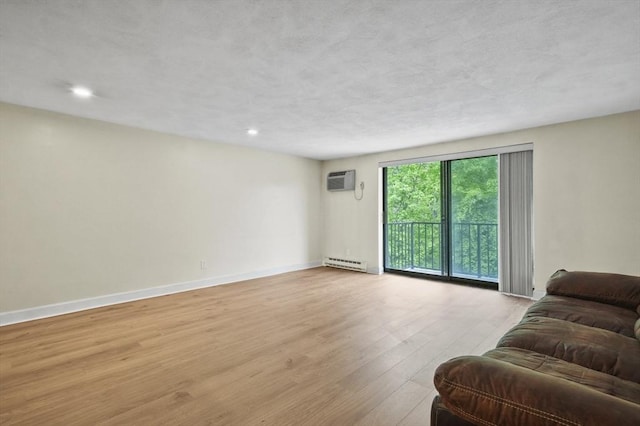 9 Broadway Unit 217, Saugus, MA 01906 - living area with a baseboard heating unit, light wood-style floors, baseboards, a wall mounted air conditioner, and recessed lighting