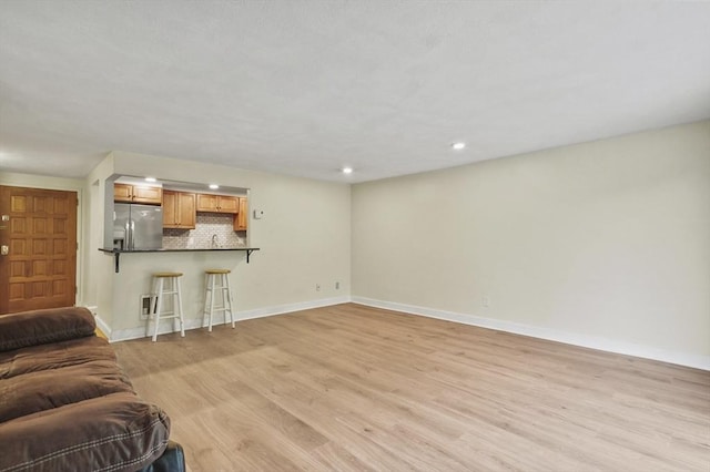 9 Broadway Unit 217, Saugus, MA 01906 - living room featuring light wood finished floors, baseboards, and recessed lighting